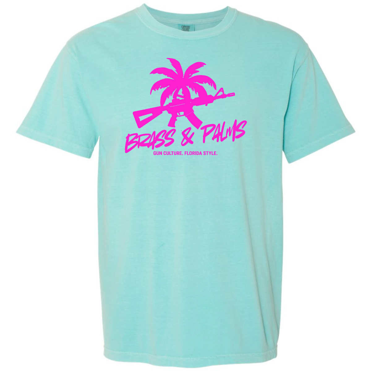A Chalky Mint aqua short-sleeve t-shirt with a bright pink graphic on the chest featuring a palm tree silhouette, a rifle, and the text 'BRASS & PALMS' with smaller text 'GUN CULTURE. FLORIDA STYLE.'