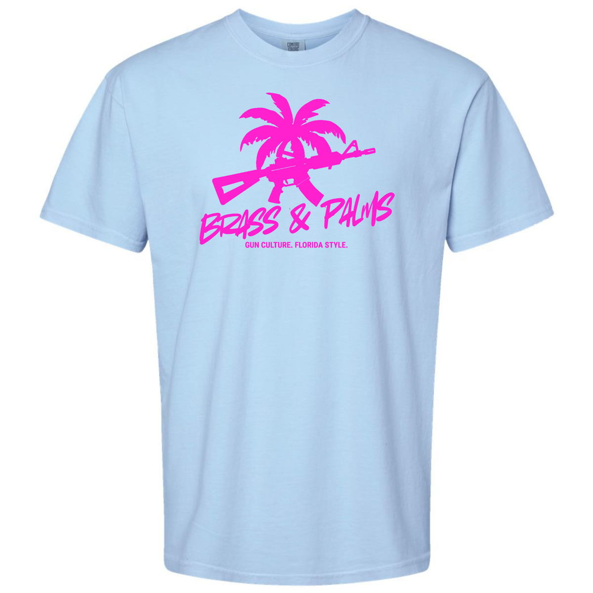 A light blue Hydrangea short-sleeve crewneck t-shirt with a bright pink graphic on the chest featuring a palm tree silhouette, a rifle, and the text 'BRASS & PALMS' and 'GUN CULTURE. FLORIDA STYLE.'.