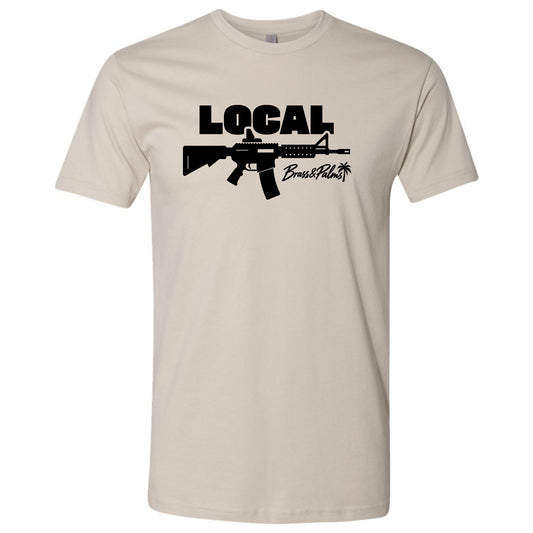 A sand-colored modern fit T-shirt with black LOCAL graphic and Brass & Palms script logo, Florida gun culture apparel.